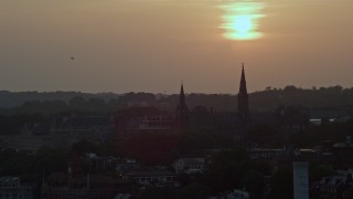AX76_109 - 4.8K aerial stock footage of Georgetown University in Washington D.C., setting sun in background