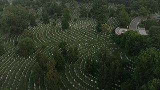 AX76_119 - 4.8K aerial stock footage flying over Arlington National Cemetery gravestones, Arlington, Virginia, twilight