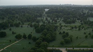 AX76_126E - 4.8K aerial stock footage flying by Arlington National Cemetery, Arlington, Virginia, twilight