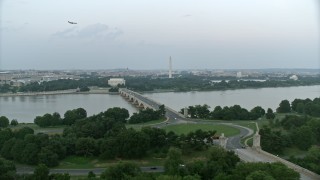 AX76_129 - 4.8K aerial stock footage of Lincoln Memorial, Washington Monument seen from Arlington Memorial Bridge, Washington, D.C., twilight