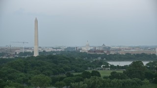 AX76_130 - 4.8K aerial stock footage of Washington Monument, Yates Building, the United States Capitol in Washington, D.C., twilight