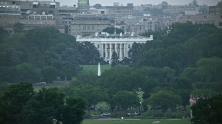 AX76_131E - 4.8K aerial stock footage of the White House, eclipsed by Washington Monument, Washington, D.C., twilight