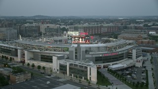 AX76_138 - 4.8K stock footage aerial video flying by Nationals Park, crowded with spectators, Washington, D.C., twilight