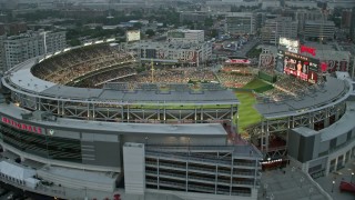 AX76_139 - 4.8K stock footage aerial video flying by Nationals Park crowded with fans, Washington, D.C., twilight