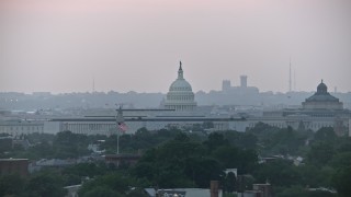 AX76_140E - 4.8K aerial stock footage of the United States Capitol dome and James Madison Building in Washington, D.C., twilight