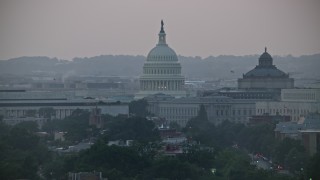 AX76_142 - 4.8K aerial stock footage of the United States Capitol dome between the James Madison and Thomas Jefferson Buildings in Washington, D.C., twilight