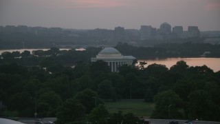 AX76_149 - 4.8K aerial stock footage of the Jefferson Memorial beside Tidal Basin in Washington, D.C., twilight