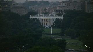 AX76_150 - 4.8K aerial stock footage of the White House, eclipsed by Washington Monument, Washington, D.C., twilight