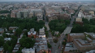 AX76_156 - 4.8K aerial stock footage of Pennsylvania Avenue and M Street, Georgetown, Washington, D.C., twilight