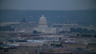AX76_157 - 4.8K aerial stock footage of the Thomas Jefferson Building and United States Capitol seen from Georgetown, Washington, D.C., twilight