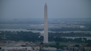 AX76_159 - 4.8K aerial stock footage of the Washington Monument, the Jefferson Memorial, and Reagan National Airport in Washington, D.C., twilight