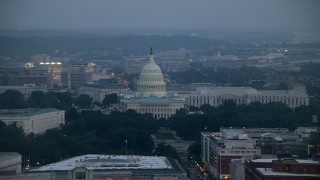 AX76_161E - 4.8K aerial stock footage of the United States Capitol and the Rayburn House Office Building, Washington, D.C., twilight