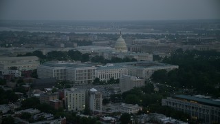 AX76_165 - 4.8K stock footage aerial video of the United States Capitol behind the Russell, Dirksen and Hart Senate Office Buildings, Washington, D.C., twilight