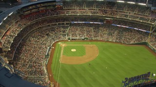 AX76_172E - 4.8K stock footage aerial video flying by a baseball game at Nationals Park, Washington, D.C., twilight