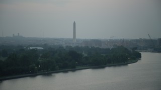 AX76_176 - 4.8K aerial stock footage of the Washington Monument seen from East Potomac Park in Washington, D.C., twilight
