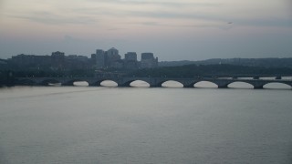 AX76_180 - 4.8K aerial stock footage of Arlington Memorial Bridge spanning the Potomac River, Washington, D.C., twilight