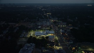 AX76_188E - 4.8K stock footage aerial video following Columbia Pike through Arlington, Virginia, night