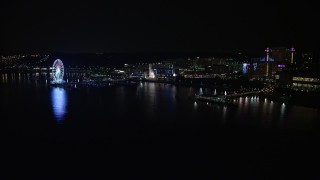 AX77_013 - 4.8K aerial stock footage of the Capitol Wheel, apartment buildings, and Gaylord National Resort and Convention Center, National Harbor, Maryland, night