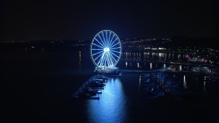 AX77_015 - 4.8K stock footage aerial video of the Capitol Wheel and marina, reveal Gaylord National Resort & Convention Center, National Harbor, Maryland, night