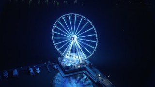 AX77_019 - 4.8K aerial stock footage of the Capitol Wheel and National Harbor Marina, Maryland, night