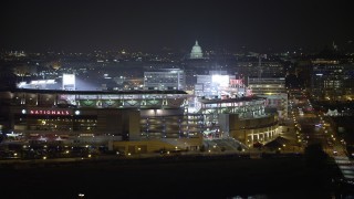 AX77_024 - 4.8K aerial stock footage of Nationals Park and United States Capitol, Washington, D.C., night