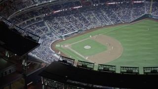 AX77_034 - 4.8K stock footage aerial video approaching baseball game in progress at Nationals Park in Washington, D.C., night