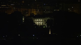 AX77_040 - 4.8K aerial stock footage of The White House, eclipsed by Washington Monument, Washington, D.C., night