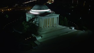 AX77_045 - 4.8K aerial stock footage of the Jefferson Memorial with visitors in Washington, D.C., night