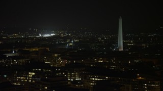 AX77_062 - 4.8K aerial stock footage of the lights of Nationals Park and the Washington Monument in Washington, D.C., night