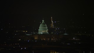 AX77_067 - 4.8K aerial stock footage of the United States Capitol building in Washington, D.C., night