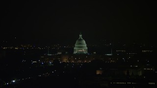 AX77_071 - 4.8K aerial stock footage of the United States Capitol Building and dome in Washington, D.C., night