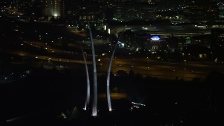 AX77_073 - 4.8K aerial stock footage flying by United States Air Force Memorial, Arlington National Cemetery, Arlington, Virginia, night