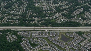 AX78_020 - 4.8K aerial stock footage of a bird's eye view of light traffic on Interstate 66 between suburban homes and apartment complexes in Centreville, Virginia
