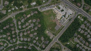 AX78_024E - 4.8K aerial stock footage of a bird's eye view of homes, Fair Oaks Hospital, reveal Navy Elementary School in Fairfax, Virginia