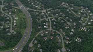 AX78_036E - 4.8K aerial stock footage of suburban homes, streets, trees, light traffic on Fairfax County Parkway, Herndon, Virginia