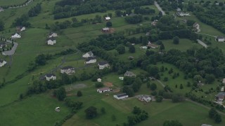 AX78_057E - 4.8K aerial stock footage or rural homes and barns in Brookeville, Maryland