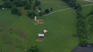 AX78_059 - 4.8K aerial stock footage of a barn and silo in Brookeville, Maryland