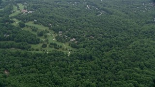 AX78_063E - 4.8K aerial stock footage flying over forest to approach Hobbit's Glen Golf Course in Columbia, Maryland