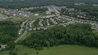 AX78_073 - 4.8K stock footage aerial video flying over Worthington Park and tract homes to approach Taylor Village Center and town homes in Ellicott City, Maryland