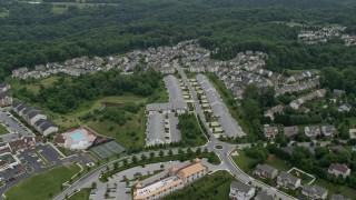 AX78_074 - 4.8K aerial stock footage of town homes and forest in Ellicott City, Maryland