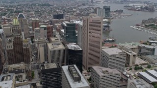 AX78_097E - 4.8K stock footage aerial video of Downtown Baltimore skyscrapers, Inner Harbor in the background, Maryland