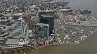 AX78_101 - 4.8K stock footage aerial video approaching Marriott and Four Seasons hotels, Legg Mason Tower, and Harbor East Marina in Baltimore, Maryland