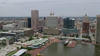 AX78_110 - 4.8K stock footage aerial video of Downtown Baltimore skyscrapers, office buildings, and Harborplace waterfront pavilions in Maryland