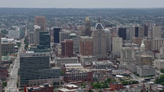 AX78_114E - 4.8K stock footage aerial video flying by skyscrapers and city buildings in Downtown Baltimore, Maryland