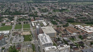 AX78_117E - 4.8K aerial stock footage flying over Johns Hopkins Hospital buildings to approach urban neighborhoods in Baltimore, Maryland