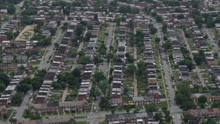 AX78_121 - 4.8K stock footage aerial video approaching urban row houses in Baltimore, Maryland