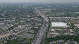 AX78_128E - 4.8K aerial stock footage approaching office buildings, light traffic on Interstate 95, and apartment buildings in Baltimore, Maryland