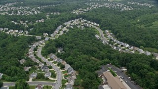 AX78_144 - 4.8K aerial stock footage flying over suburban houses by Abingdon Fire Company in Abigdon, Maryland
