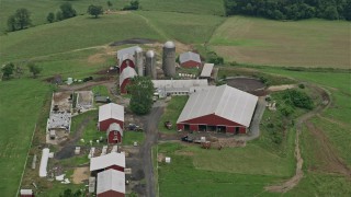 AX78_146 - 4.8K aerial stock footage of silos and red barns in Abigdon, Maryland