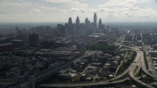 AX79_004E - 4.8K aerial stock footage tilting from Benjamin Franklin Bridge to reveal skyline of Downtown Philadelphia, Pennsylvania